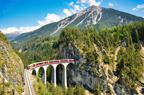 Railway bridge in Switzerland. Landwasser Viaduct in Graubunden near Davos Klosters Filisur. Railway company emblem.