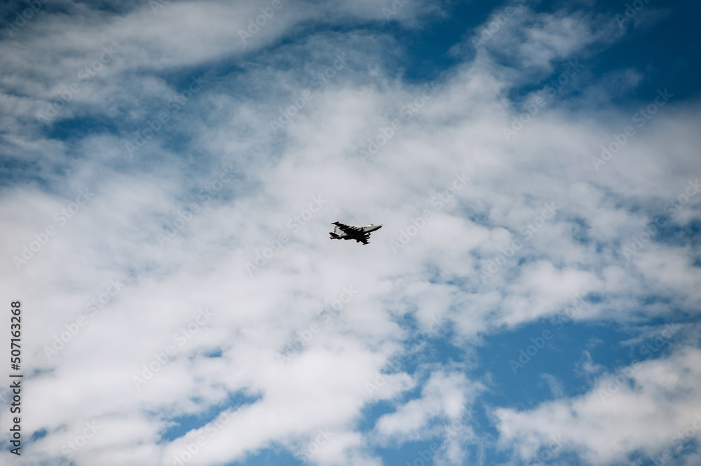 A large military fighter jet flies in the sky.