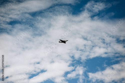 A large military fighter jet flies in the sky.