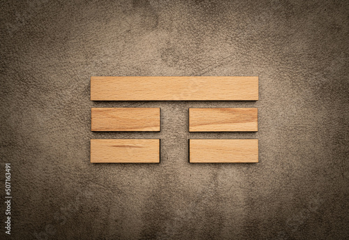 Trigram mountain i ching element yin yang wood on leather background