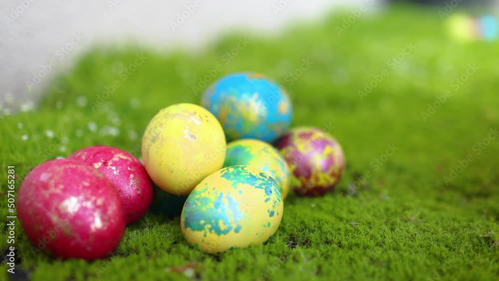 spring egg hunt. little hands grabbing the colorful easter eggs on the fresh grass spring egg hunt. little hands grabbing the colorful easter eggs on the fresh grass