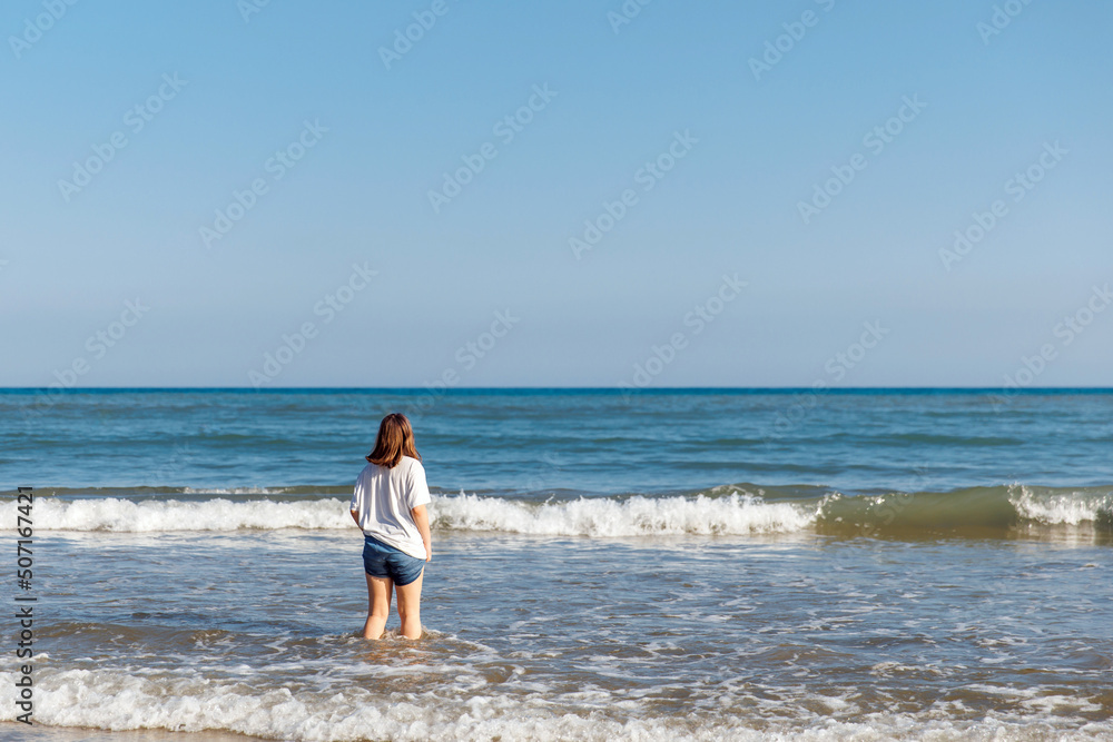 Portrait of a teenage girl on the beach, summer holidays by the sea Portrait of a teenage girl on the beach, summer holidays by the sea