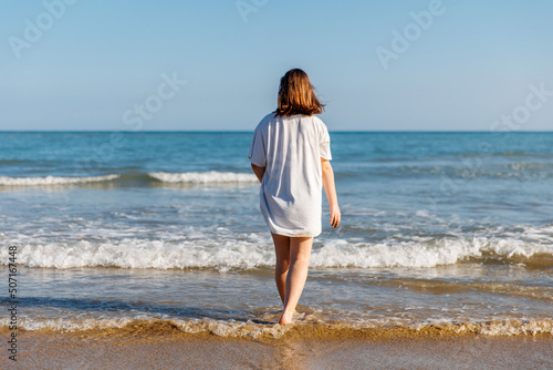 Portrait of a teenage girl on the beach, summer holidays by the sea