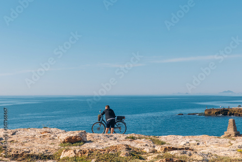 Cyclist relaxes by the sea, healthy lifestyle