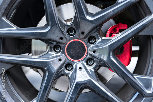 red brake caliper wheels of a powerful car, brake disc. 