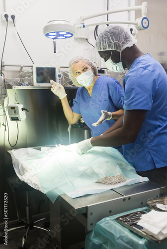 Nurse points to surgeon on computer screen. High quality photo