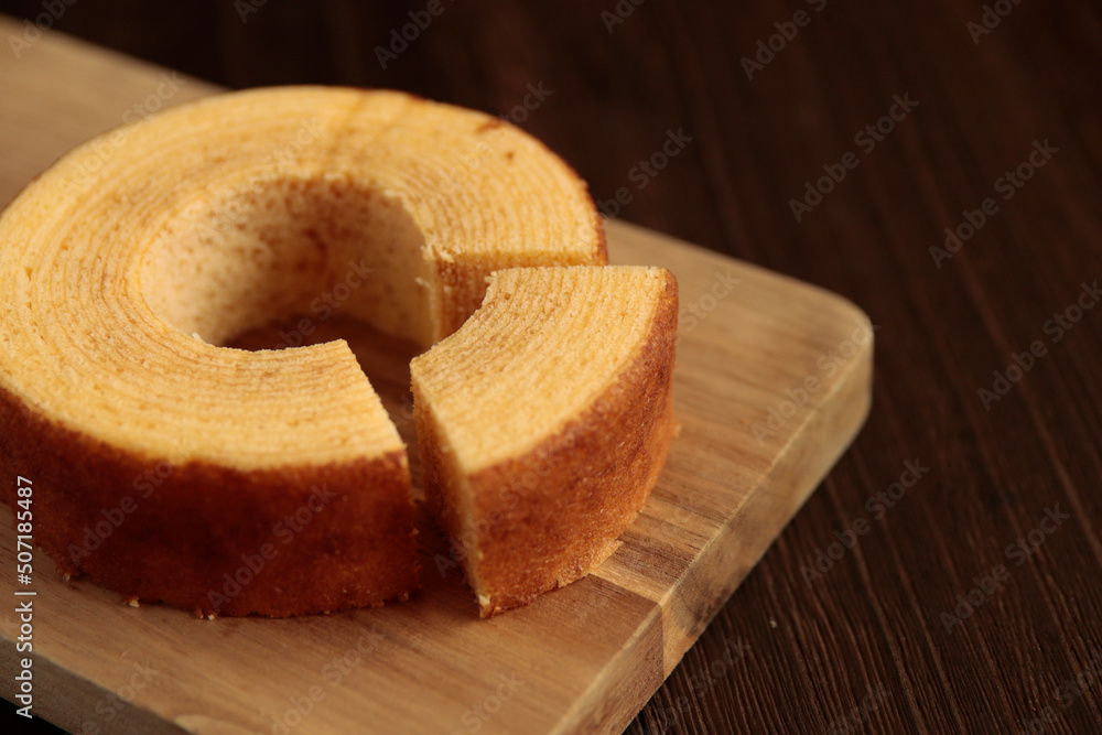 Eating Baumkuchen as a gift at a wedding ceremony at the table at tea time
 - obrazy, fototapety, plakaty 