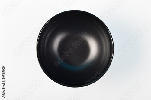Black plastic bowl isolated on a white background