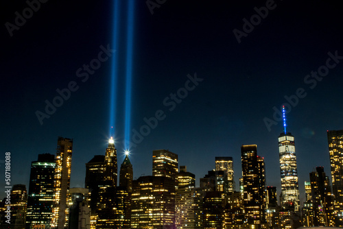 The Tribute in Light shines 4 miles into the sky from Lower Manhattan, with the One World Trade Center, the Freedom Tower, to the right photo