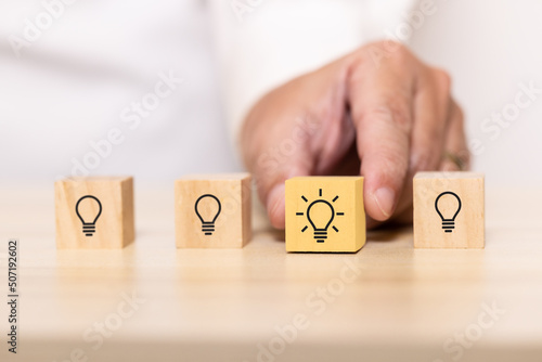 hand pick wooden blocks with thinking and idea icon. Concept for creative and design solution.