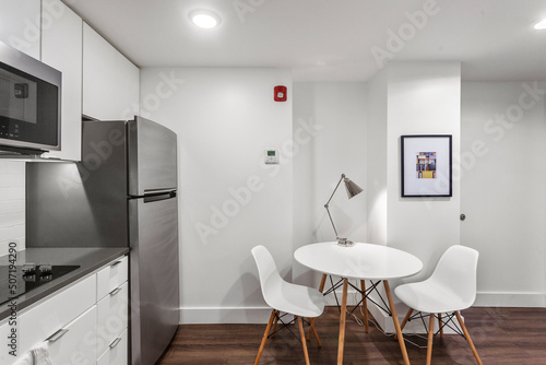 Wallpaper Mural White apartment kitchen with black counter tops and white cabinets in city apartment Torontodigital.ca