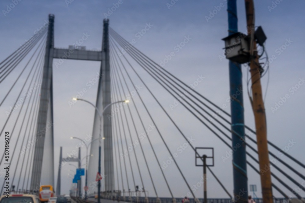 Naklejka premium Blurred image , Image shot through car, 2nd Hoogly bridge at blue hour. Monsoon stock image.