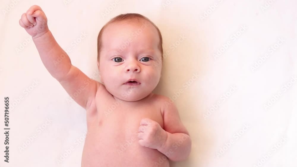 Video portrait of a baby toddler on a white background . Happy baby. A happy child. An infant looks into the camera . White background. High quality FullHD footage Video portrait of a baby toddler on a white background . Happy baby. A happy child. An infant looks into the camera . White background. High quality FullHD footage