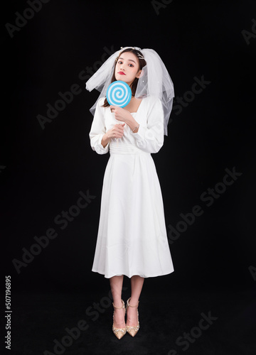 A young woman in a white dress and veil