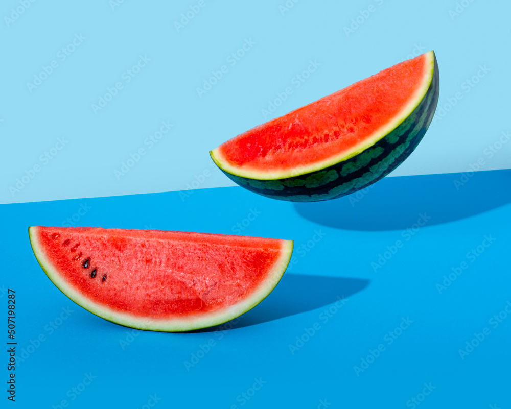 Two watermelons on blue paper (floating) Two watermelons on blue paper (floating)