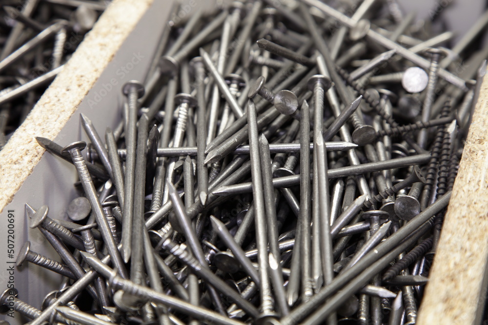 A lot of new common nails in pile. Carpentry construction fasteners. Industrial equipment tools. A lot of new common nails in pile. Carpentry construction fasteners. Industrial equipment tools.