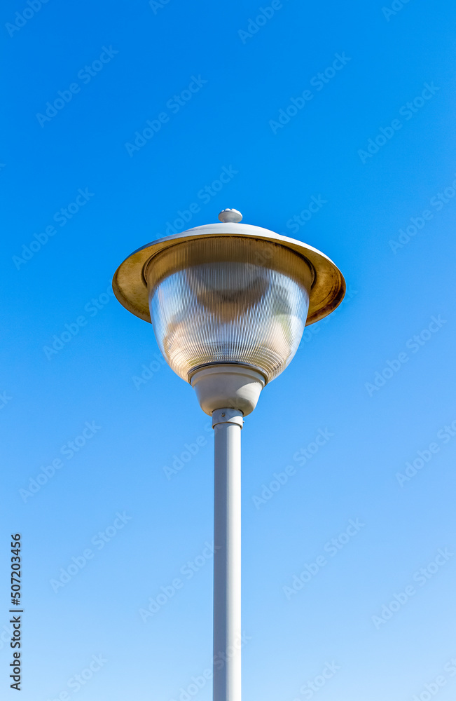 Metal street city lamp on a background of a clear sky close-up. Metal street city lamp on a background of a clear sky close-up.