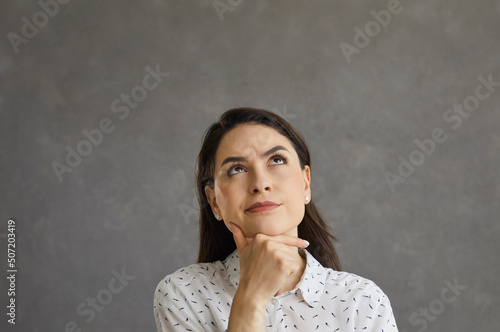 Obraz na plátně Studio portrait of serious confused undecided beautiful young woman or student g