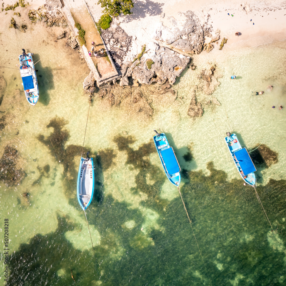 Aerial view of the Akumal Bay in Quintana Roo, Mexico. Caribbean Sea, coral reef, top view. Top view of fishing boats near the shore