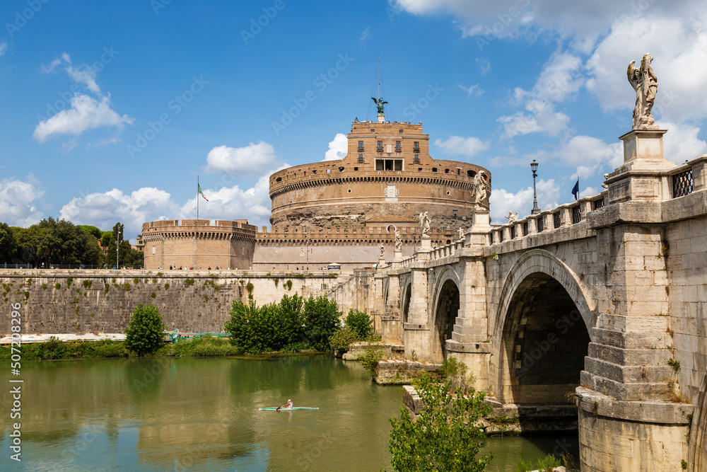Cityscape of Rome with Castel Sant'Angelo and Ponte Sant'Angelo across the Tiber river on a sunny summer day. Rome, Italy