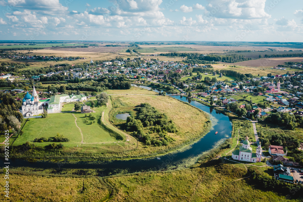 Aerial view panorama of cityscape of the Suzdal Kremlin on a bend of the Kamenka river. Russia, Vladimir region, Golden Ring of Russia