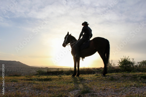 silhouette horse and rider , sunrise time man ride horse