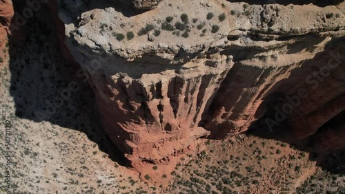 Aerial drone view of a awesome red rock formation in a red dessert canyon in Teruel. spain photo