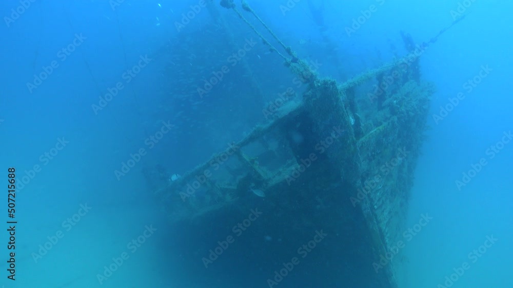 Deep scuba diving - Shipwreck over a sand seabed in cloudy sea water Deep scuba diving - Shipwreck over a sand seabed in cloudy sea water