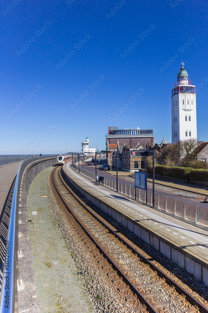 Railroad track and lighthouse in the harbor of Harlingen, Netherlands Railroad track and lighthouse in the harbor of Harlingen, Netherlands