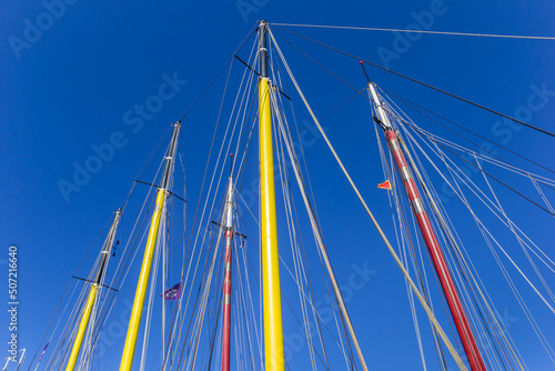 Colorful masts of sailing ships in the harbor of Harlingen, Netherlands