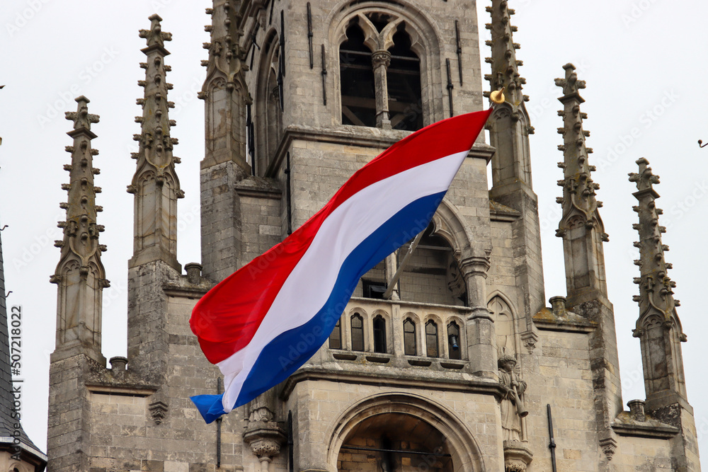 Fototapeta premium Flags on the ancient town hall at the Markt of Gouda during celebration of 750 years Gouda