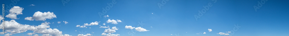 Fototapeta premium White clouds in blue summer sky panoramic background