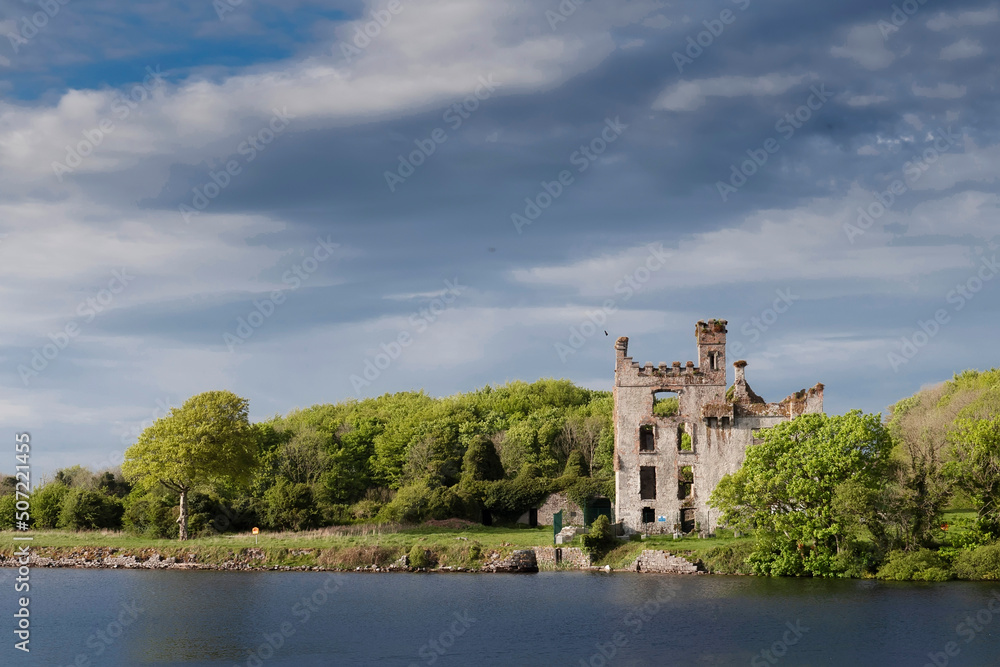 River Corrib and clean Menlo castle after restoration work completed. Warm sunny day. Beautiful cloudy sky. Galway city, Ireland. Popular historic building and landmark. River Corrib and clean Menlo castle after restoration work completed. Warm sunny day. Beautiful cloudy sky. Galway city, Ireland. Popular historic building and landmark.