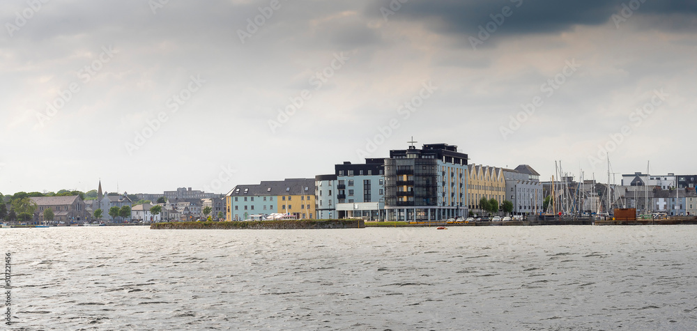View on River Corrib and Galway harbor. Ireland. Bayview houses. High tide. Panorama image. Popular town area Claddagh and Long Walk.