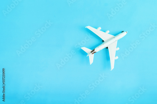 Travel flat lay composition airplane on yellow background with copy space