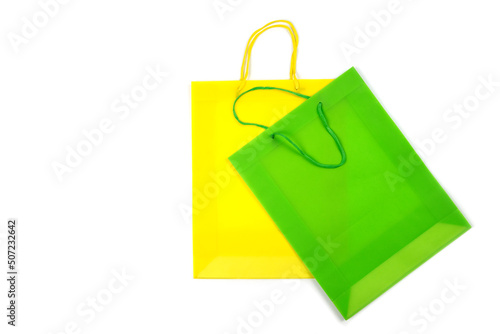 Green and yellow shopper bags isolated on white