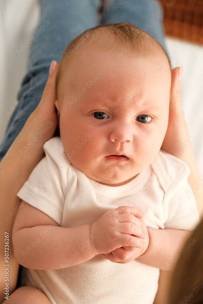 newborn baby in mom's arms. in the background the light from the window .the concept of mother's love for the child newborn baby in mom's arms. in the background the light from the window .the concept of mother's love for the child