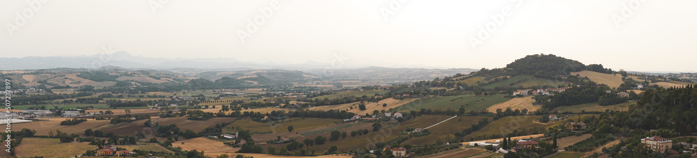 Panoramic view of Marche hills. Italian countryside in central Italy, in the Marche region. Mountains, hills and forests under blue skies. Hot summer and climate change. Osimo, Ancona, Urbino.