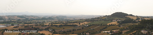 Panoramic view of Marche hills. Italian countryside in central Italy, in the Marche region. Mountains, hills and forests under blue skies. Hot summer and climate change. Osimo, Ancona, Urbino. © Pier Fax