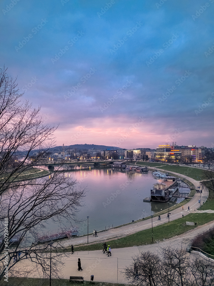 KRAKOW, POLAND, 7 JANUARY 2022: View of the Vistula River at twilight KRAKOW, POLAND, 7 JANUARY 2022: View of the Vistula River at twilight