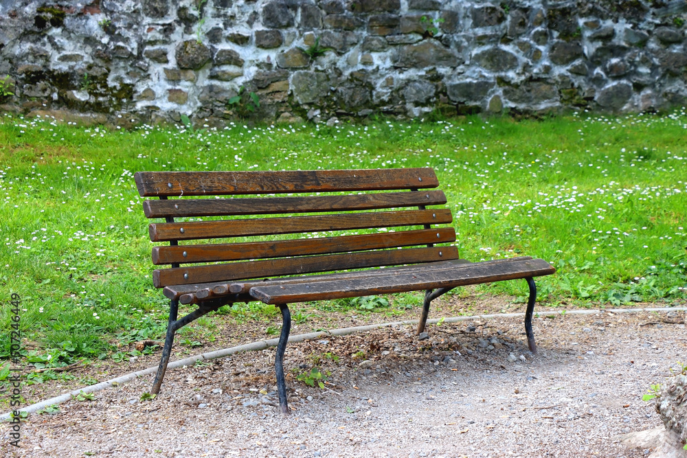 Green bench and colorful flowers and plants in the beautiful park. Spring or summer day in Zagreb, Croatia. Selective focus. Green bench and colorful flowers and plants in the beautiful park. Spring or summer day in Zagreb, Croatia. Selective focus.