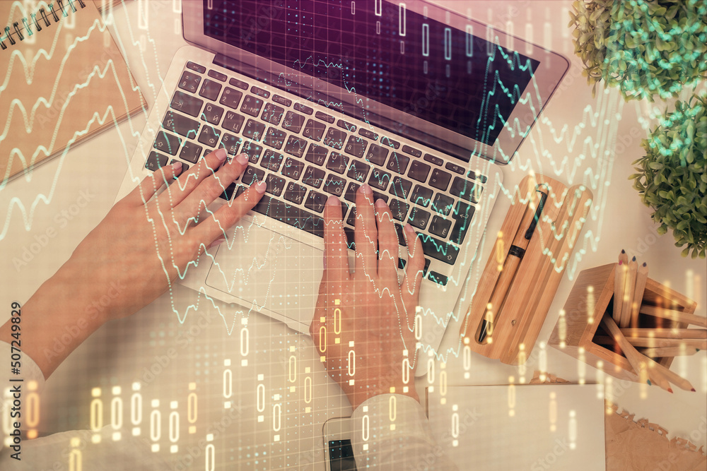 Double exposure of woman hands working on computer and forex chart hologram drawing. Top View. Financial analysis concept. Double exposure of woman hands working on computer and forex chart hologram drawing. Top View. Financial analysis concept.