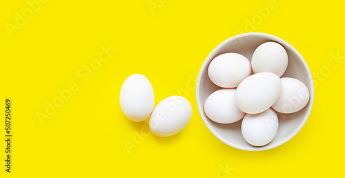 White eggs on yellow background.