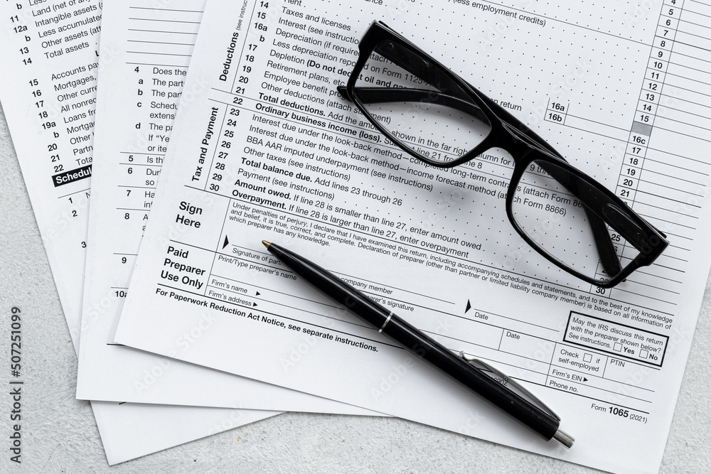 Businessman table with US tax form and pen. Culculating and payment of taxes Businessman table with US tax form and pen. Culculating and payment of taxes