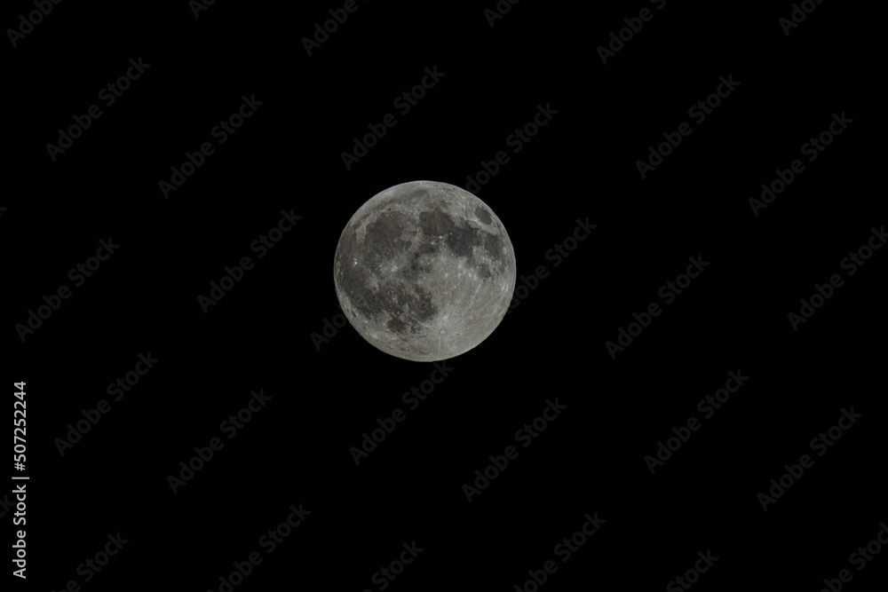 Fototapeta premium Full moon. Black background. Isolated