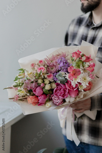 Bright bouquet of flowers in hands