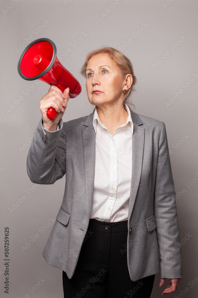 Business woman making announcement with megaphone or loudspeaker Business woman making announcement with megaphone or loudspeaker