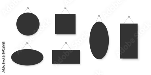 Realistic empty blank black signboards hanged on metal holders. Circle, rectangle, oval and square frame templates hanging on wall. Price tags mockup. Advertisement, promotion isolated on white.