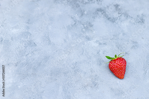 Ripe, juicy strawberries on a blue background. Summer berries.