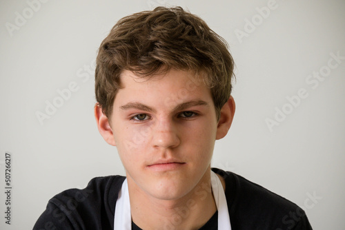 A Teenage Boy Cooking In A Kitchen